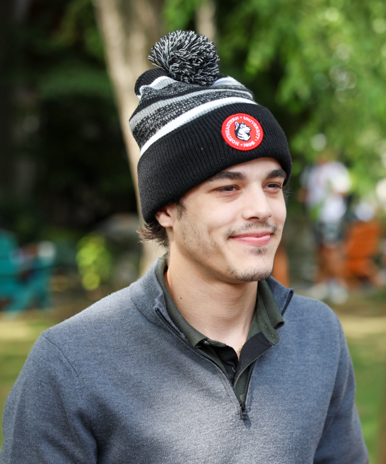 Black hat with black pom pom sales